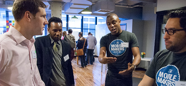 App showcase at Meet the Makers students show app to guests at Mobile Makers Academy open house