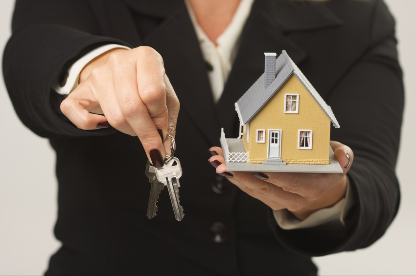 Woman handing over keys to new home